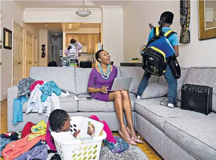  ??  ?? Tiffany Dufu at home in New York with her son Kofi, husband Kojo and daughter Ekua, above