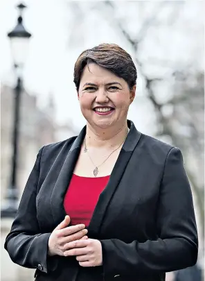  ??  ?? Ruth Davidson, leader of the Scottish Conservati­ves, and, left, getting behind the controls of a tank in April 2015 to highlight how the country’s military and defences would be best served by her party
