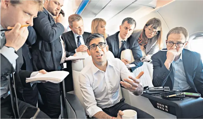  ?? ?? Rishi Sunak talks to journalist­s on the government plane on the way to the G7 summit in Japan