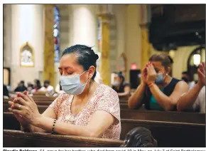  ?? (AP Photo/Jessie Wardarski) ?? Claudia Balderas, 51, prays for her brother, who died from covid-19 in May, on July 7 at Saint Bartholome­w Roman Catholic Church in the Queens borough of New York.