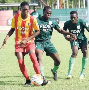  ?? FILE ?? Cornwall College’s Shavon McDonald (left) is tackled by Morant Bay High’s Renardo Buckly (centre) and Kenton Lewis at the Montego Bay Sports Complex last Saturday. Cornwall won the ISSA/FLOW daCosta Cup second round match 8-0.