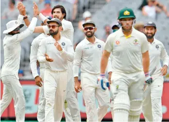  ??  ?? Indian cricket team celebrate the wicket of Australian batsman Aaron Finch in this file photo.