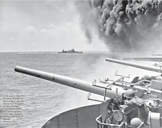  ??  ?? In this June 4, 1942, file photo provided by the U.S. Navy, the USS Astoria (CA-34) steams by USS Yorktown (CV-5) shortly after the carrier had been hit by three Japanese bombs in the battle of Midway.
William G. Roy/ U.S. Navy via AP