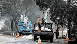  ?? BEN MARGOT/AP ?? PG &amp; E crews work on restoring power in October. The company will file for bankruptcy.