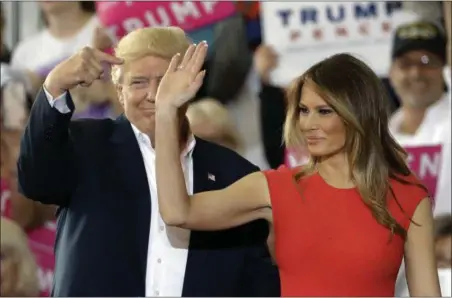  ?? CHRIS O’MEARA — THE ASSOCIATED PRESS ?? President Donald Trump points to his wife, first lady Melania Trump during a campaign rally Saturday at Orlando-Melbourne Internatio­nal Airport, in Melbourne, Fla.