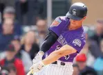  ?? BEN MARGOT/ASSOCIATED PRESS ?? Colorado’s Ryan McMahon, shown connecting for an RBI-double during a spring game last month, has hopes to secure the starting job at first base.