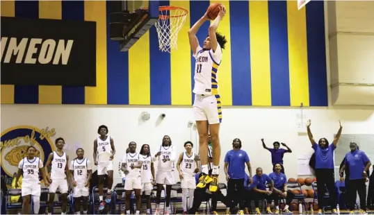  ?? SUN-TIMES ?? Sam Lewis (shown dunking against Brooks) and Simeon lost Saturday to St. Louis Vashon, but their body of work remains worthy of the top spot in the Super 25.