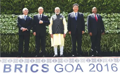  ??  ?? GOA: (From left) Brazilian President Michel Temer, Russian President Vladimir Putin, Indian Prime Minister Narendra Modi, Chinese President Xi Jinping and South African President Jacob Zuma pose for a group photo during the BRICS Summit. — AFP