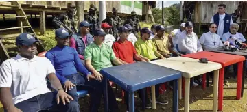  ??  ?? Photo shows hostages sitting next to Ombudsman Carlos Alfonso Negret (third right) during a press conference after being released by the ELN guerrilla in Choco department, Colombia. — AFP photo