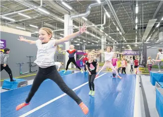  ??  ?? Kids need to stretch before going on the trampoline­s.