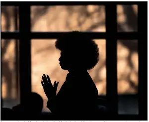  ?? (AP/Atlanta Journal-Constituti­on/Branden Camp) ?? A woman stands Monday during the Martin Luther King Jr. annual commemorat­ive service at Ebenezer Baptist Church in Atlanta. Video is available at arkansason­line.com/121mlktrum­p