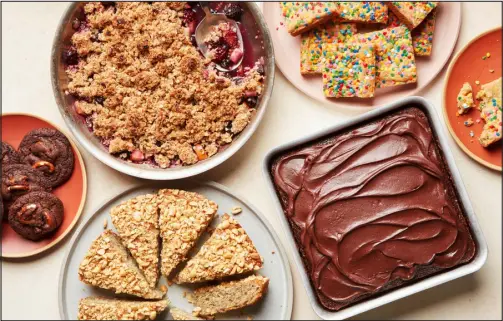  ?? PHOTOS BY JOSEPH DE LEO — THE NEW YORK TIMES ?? Clockwise from left: chunky chocolate cookies, fruit crumble, birthday cake blondies, one-bowl chocolate cake and vegan banana bread. If you’re a beginner in the kitchen, baking is an ideal entry point.