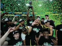  ?? JOHN LOCHER — THE ASSOCIATED PRESS ?? Oregon players celebrate after defeating Colorado in the final Pac-12 championsh­ip Sunday in Las Vegas. Oregon joins the Big Ten this fall.