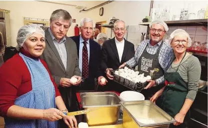  ??  ?? Präsident Landau, Franz Küberl und Helmut Schüller mit Freiwillig­en in einer Caritas-Küche