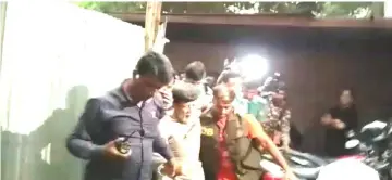  ??  ?? Alam is taken into custody by detective branch personnel outside of the Metropolit­an Magistrate’s court in Dhaka, Bangladesh in this still image taken from a video obtained by Reuters. — Reuters photo