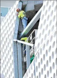  ?? AP/ WILFREDO LEE ?? A constructi­on crew works on a building in Miami Beach, Fla., in April. U. S. constructi­on spending rose 0.3 percent in March after a 1 percent gain in February, the Commerce Department said Monday.