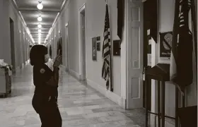  ?? Brendan Smialowski / AFP via Getty Images ?? A Capitol Hill worker takes a photo of the late Rep. John Lewis's office Monday. Georgia State Sen. Nikema Williams will take his place on the November ballot.