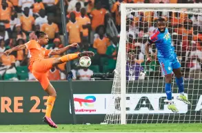  ?? — AFP photo ?? Ivory Coast’s Haller (left) kicks to score his team’s first goal during the Africa Cup of Nations (CAN) semi-final match against Democratic Repuplic of Congo at Alassane Ouattara Olympic Stadium in Ebimpe, Abidjan.
