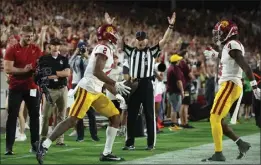  ?? CHRISTIAN PETERSEN — GETTY IMAGES ?? An official signals a touchdown as USC wide receiver Brenden Rice returns to the field after his 29-yard, toe-tap scoring catch against Arizona State on Saturday night.