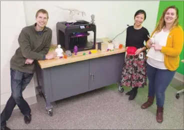  ?? BARB AGUIAR/Westside Weekly ?? Vsevolod Lynov, technical assistant, Jessica Whu, branch head, and Heather Marnier, technical assistant, show off some of the projects people can make with the 3D printer at the new Westside Learning Lab, which celebrates its official opening Saturday from 10 a.m. to 5 p.m.The 3D printer is one of the pieces of technology people can reserve with their library cards.