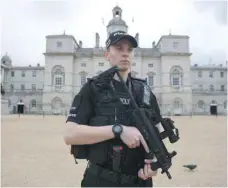  ?? — AFP ?? An armed police officer stands guard outside the Horse Guards Parade in central London on Saturday.