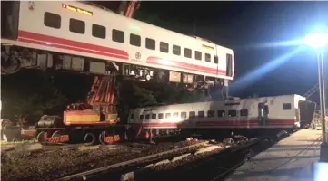  ??  ?? File photo shows a crane lifting a train which had overturned in Yilan County, Taiwan, in this still image taken from a video obtained from social media. — Reuters photo