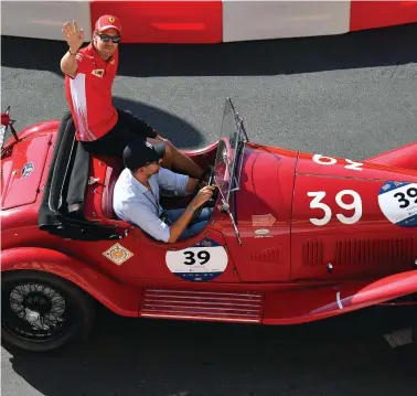  ?? EPA-EFE ?? MEET AND GREET: German Formula One driver Sebastian Vettel of Scuderia Ferrari waves to spectators during the ‘F1 Fan Festival’ in downtown Milan, Italy, this week. The Italian Grand Prix is on Sunday.