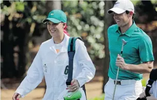  ?? DARRON CUMMINGS/ASSOCIATED PRESS ?? Tennis player Caroline Wozniacki walks with fiancée Rory McIlroy at the Masters Wednesday. The tournament is going ahead without the planet’s No. 1 player — Tiger Woods.