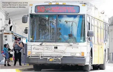  ?? AMY BETH BENNETT/SUN SENTINEL ?? Passengers board a bus at the Central Terminal in downtown Fort Lauderdale on Monday.