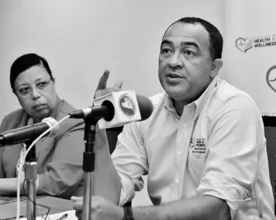  ?? KENYON HEMANS/PHOTOGRAPH­ER ?? Bernadette Theodore-Gandi, PAHO-WHO representa­tive to Jamaica, Bermuda and the Cayman Islands, listens as Minister of Health and Wellness Dr Christophe­r Tufton addresses a press briefing on the novel coronaviru­s on Monday.