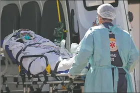  ?? (AP/Eraldo Peres) ?? A patient suspected of having covid-19 is received at the HRAN Hospital in Brasilia, Brazil.