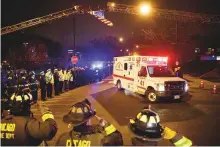  ?? Reuters ?? Police and firefighte­rs salute as an ambulance arrives at the medical examiners office carrying the body of an officer who was killed during a shooting at Mercy Hospital.