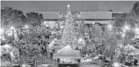  ?? Diana L. Porter / For The Chronicle ?? The Christmas tree at LaCenterra in Cinco Ranch takes center stage after the annual tree lighting ceremony in December 2014.