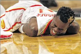  ?? ADAM HUNGER / ASSOCIATED PRESS ?? Dennis Schroder’s absence late in the game due to an ankle injury left the Hawks without a finishing kick in their 116-104 loss to the Nets.