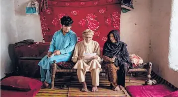  ?? JIM HUYLEBROEK/THE NEW YORK TIMES ?? Land owned by Jamal Khan, center, became a casualty of the U.S.-led war in Afghanista­n. Above, Khan and some of his family members in 2019 at their home in Watapur, Afghanista­n.