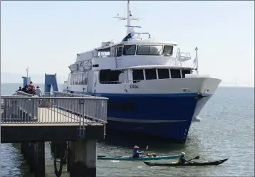  ?? ALAN DEP — MARIN INDEPENDEN­T JOURNAL ?? Golden Gate Ferry riders head down the dock last year in Sausalito. A proposal to increase ferry fares would generate an estimated $380,000to $540,000in new annual revenue for the transit district.