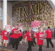  ?? AP PHOTO ?? ON STRIKE: Striking union members walk a picket line outside the Trump Taj Mahal casino in Atlantic City, N.J.