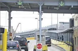  ?? Miguel Roberts Brownsvill­e Herald ?? DRIVERS PAY a toll at the Gateway Internatio­nal Bridge in Brownsvill­e, Texas, to cross into Matamoros, Mexico, where Americans sometimes seek medical care.