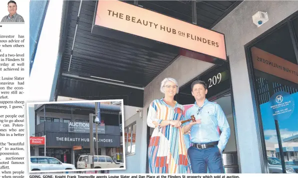  ??  ?? GOING, GOING GONE: Knight F Frank k T Townsville agents Louise Slater and Dan Place at the Flinders St property which sold at auction.