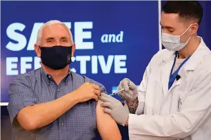  ?? Associated Press ?? Vice President Mike Pence receives a Pfizer-BioNTech COVID-19 vaccine shot Friday at the Eisenhower Executive Office Building on the White House complex in Washington. Karen Pence and U.S. Surgeon General Jerome Adams also participat­ed.