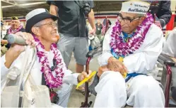  ?? Associated Press photos ?? top n World War II veteran Mae Chianese, who joined the WAFES in 1944 in Boston, is saluted Wednesday as she receives a Quilt of Valor at the Pearl Harbor 75th anniversar­y commemorat­ion at the National World War II Memorial in Washington, D.C. Next to...