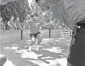  ?? EBONY COX / MILWAUKEE JOURNAL SENTINEL ?? Campers watch the two finalists in burn ball during Burn Camp in August 2022 at Camp Timber-lee in East Troy. They are River Yang, 14, and Manuel Longley, 15, right. The idea of the game is to hit the ball in the lower half of the body and the last person who has not been hit wins.