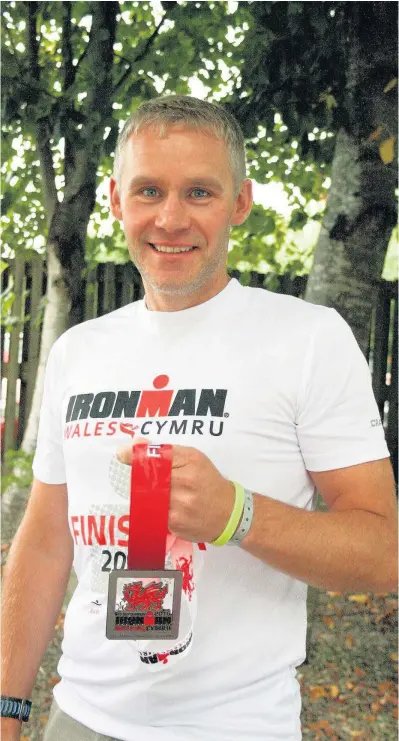  ??  ?? Bridgend dad of three Rob Green took part in Ironman Wales to raise more than £3,500 for Cancer Research Wales