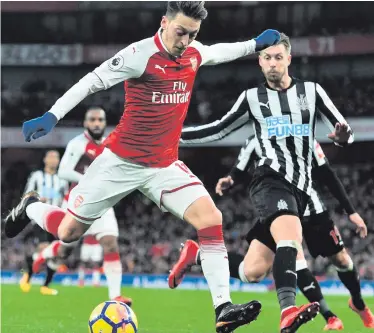  ??  ?? Forward march: Mesut Ozil closes in on goal during Arsenal’s victory over Newcastle