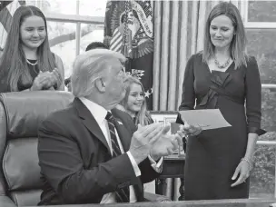  ?? DOUG MILLS/NEW YORK TIMES ?? President Donald Trump applauds Supreme Court nominee Judge Amy Coney Barrett in the Oval Office on Saturday afer giving her his nominating letter.