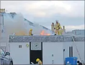  ?? 25_c51machgcf­ire03 ?? Fire tenders at the front of the club and fire fighters on the roof.