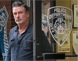  ?? PHOTO/JULIE JACOBSON ?? Actor Alec Baldwin walks out of the New York Police Department's 10th Precinct Friday in New York. Baldwin was arrested Friday after allegedly punching a man in the face during a dispute over a parking spot outside his New York City home, authoritie­s said.