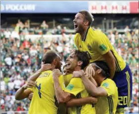  ?? MARTIN MEISSNER — THE ASSOCIATED PRESS ?? Sweden’s Andreas Granqvist, left, celebrates with teammates after scoring his side’s second goal against Mexico, Wednesday.
