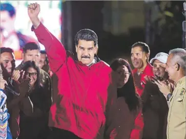  ?? Ronaldo Schemidt AFP/Getty Images ?? PRESIDENT Nicolas Maduro celebrates the results of the vote to elect a new constituti­onal assembly in Venezuela. “The assembly will allow [the imposition of] order,” Maduro said. “Some will end up in a jail cell.”