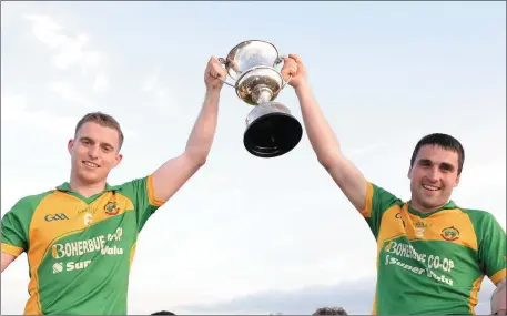  ??  ?? Boherbue joint captains Kevin Cremin and Niall Murphy lift the E Tarrant & Sons Skoda Dealer Duhallow JAFC trophy following their 2019 final win over Lyre at Castlemagn­er.